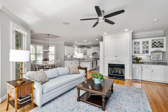 153 Longwood Green Ct, Aiken, SC 29803 - living room with crown molding, recessed lighting, light wood finished floors, and ceiling fan with notable chandelier