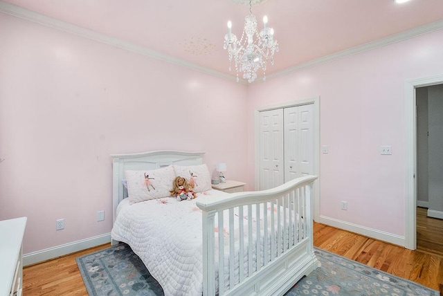 153 Longwood Green Ct, Aiken, SC 29803 - bedroom featuring an inviting chandelier, baseboards, and wood finished floors