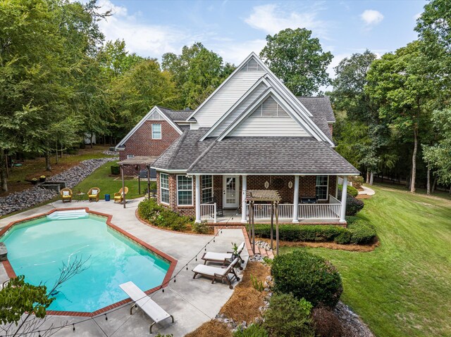 back of property featuring a yard and a patio area