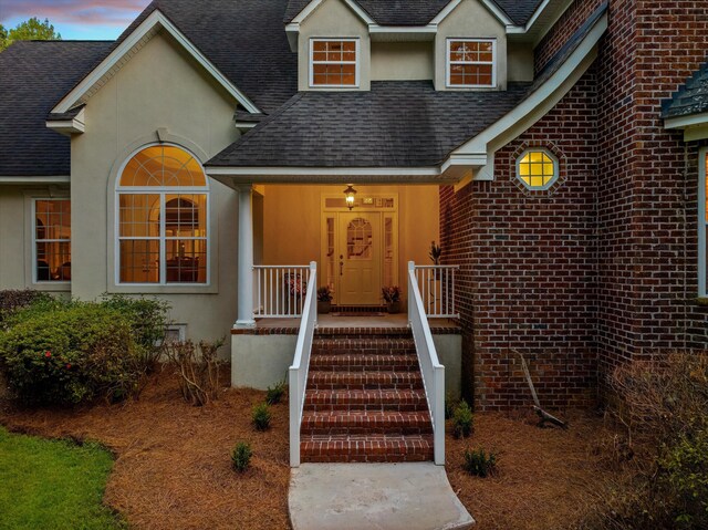 view of exterior entry at dusk