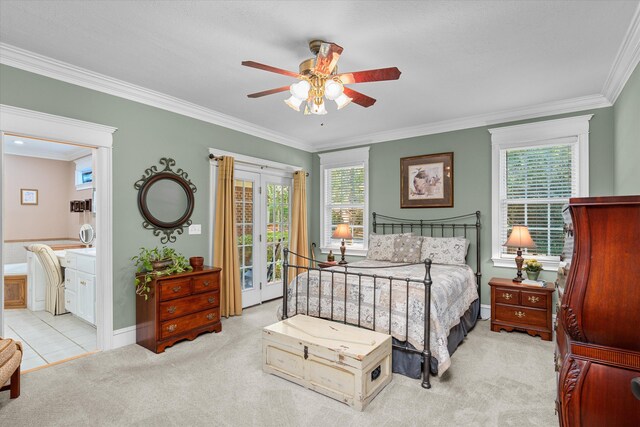 carpeted bedroom with multiple windows, connected bathroom, ceiling fan, and ornamental molding