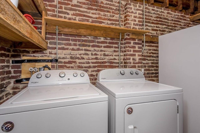 418 Kemp Dr, Augusta, GA 30909 - laundry room featuring brick wall and separate washer and dryer