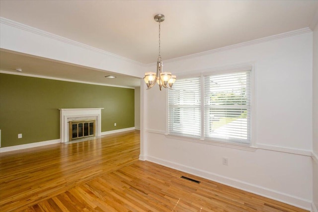 418 Kemp Dr, Augusta, GA 30909 - unfurnished room with crown molding, a chandelier, light wood-type flooring, and a fireplace with flush hearth