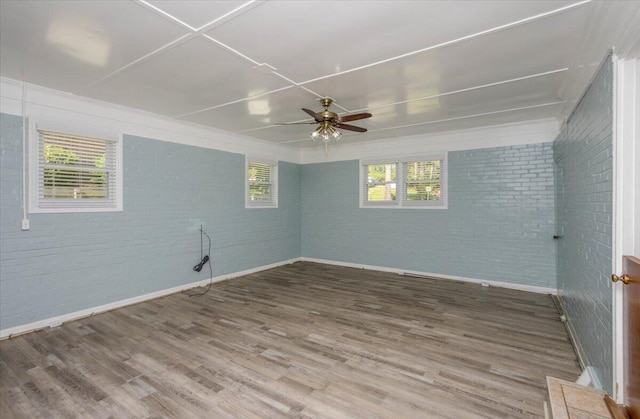 418 Kemp Dr, Augusta, GA 30909 - spare room featuring brick wall, wood finished floors, and ceiling fan