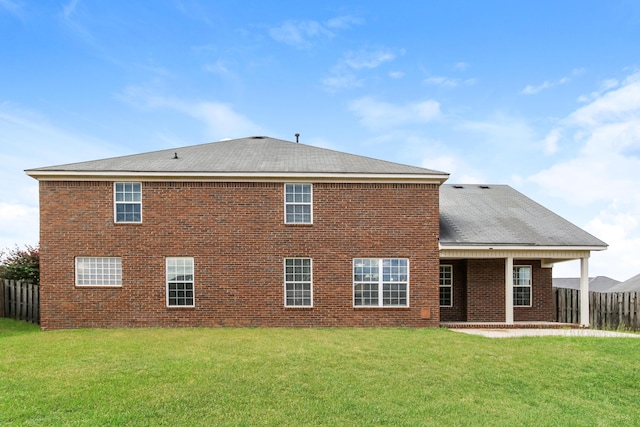 rear view of house with a lawn