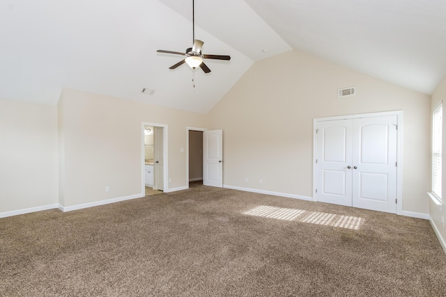 unfurnished bedroom featuring a closet, carpet floors, ensuite bathroom, and ceiling fan