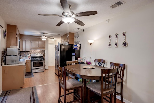 431 Edgar Cir, Thomson, GA 30824 - dining space with light wood-style flooring, ceiling fan, and a textured ceiling