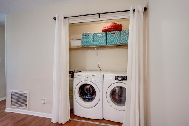 431 Edgar Cir, Thomson, GA 30824 - laundry area with washer and dryer, wood finished floors, and baseboards