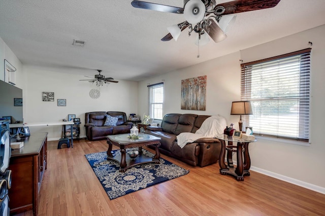 431 Edgar Cir, Thomson, GA 30824 - living area with ceiling fan, wood finished floors, baseboards, and a textured ceiling