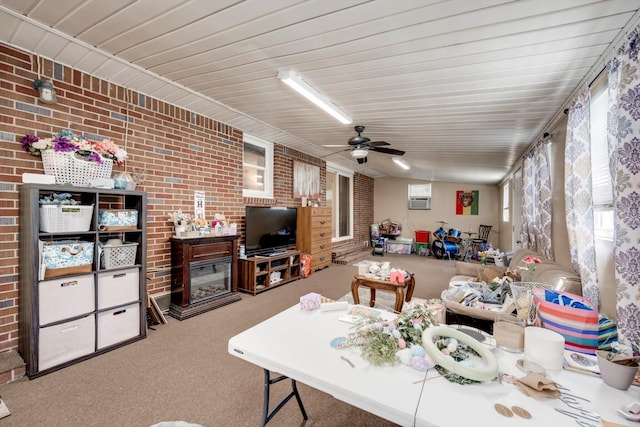431 Edgar Cir, Thomson, GA 30824 - living room featuring brick wall, carpet flooring, and ceiling fan