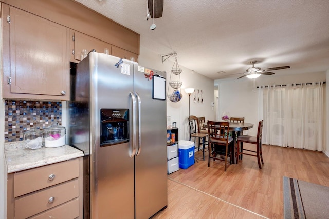 431 Edgar Cir, Thomson, GA 30824 - kitchen with stainless steel fridge, a ceiling fan, light wood finished floors, backsplash, and light countertops
