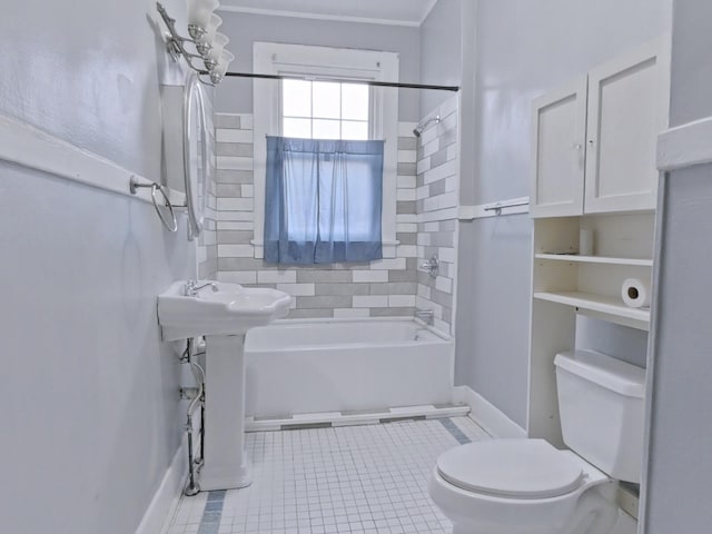 full bath with tile patterned floors, toilet, baseboards, and washtub / shower combination