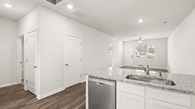 kitchen with light stone countertops, white cabinetry, sink, ceiling fan, and stainless steel dishwasher