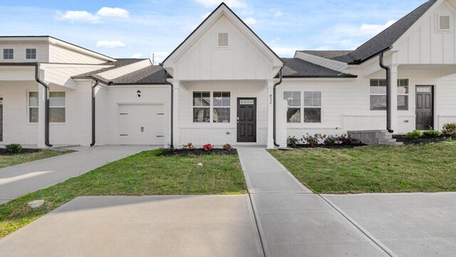 view of front of property featuring a garage and a front lawn