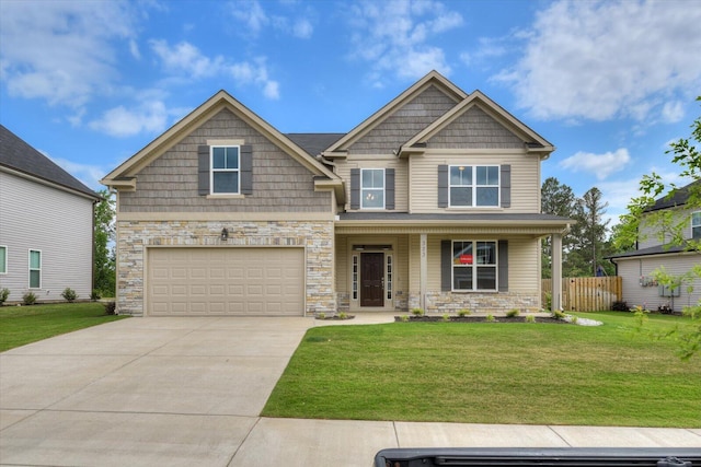 craftsman-style house featuring a garage, covered porch, and a front lawn