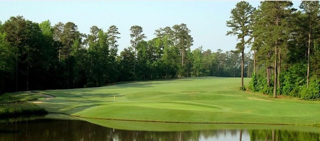 view of home's community with a water view and golf course view