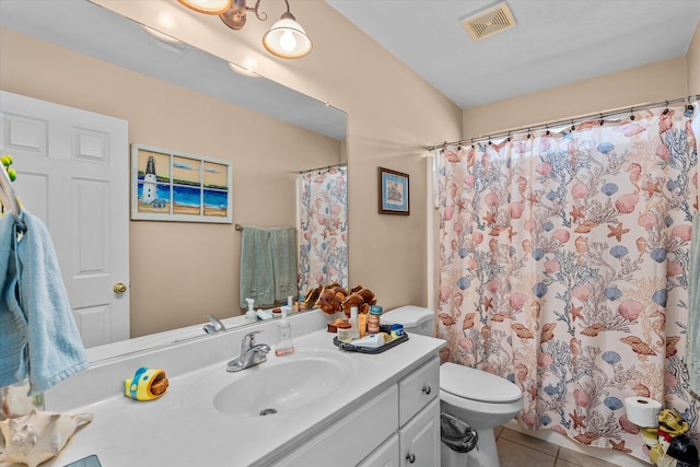 bathroom with tile patterned floors, vanity, and toilet