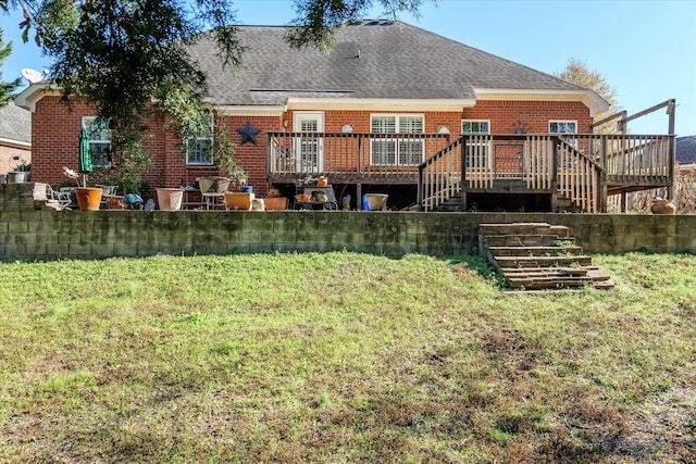 back of property with a deck and a lawn