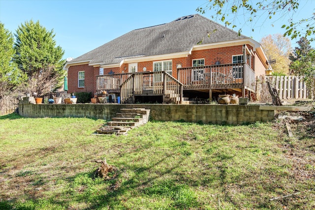 back of house featuring a yard and a wooden deck