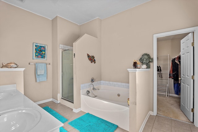 bathroom featuring tile patterned floors, vanity, and shower with separate bathtub