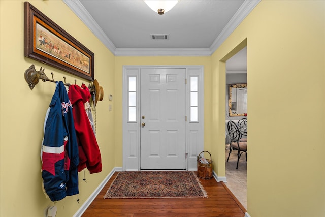 foyer with wood-type flooring and ornamental molding