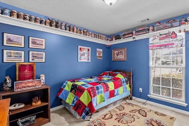 carpeted bedroom with a textured ceiling