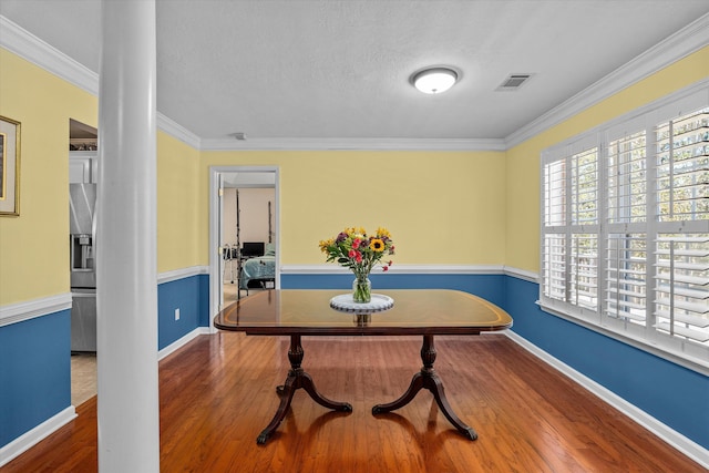 dining room featuring hardwood / wood-style flooring and ornamental molding