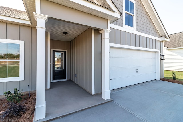 doorway to property with a garage