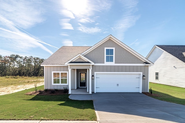 view of front of property featuring a garage and a front lawn