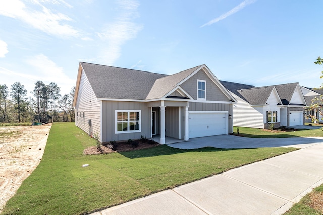 view of front of property with a front yard and a garage