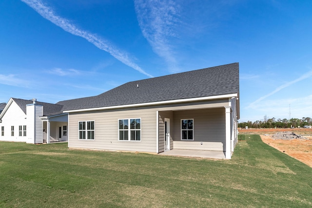 rear view of house with a patio area and a yard