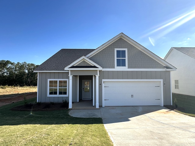 view of front of house featuring a front yard and a garage