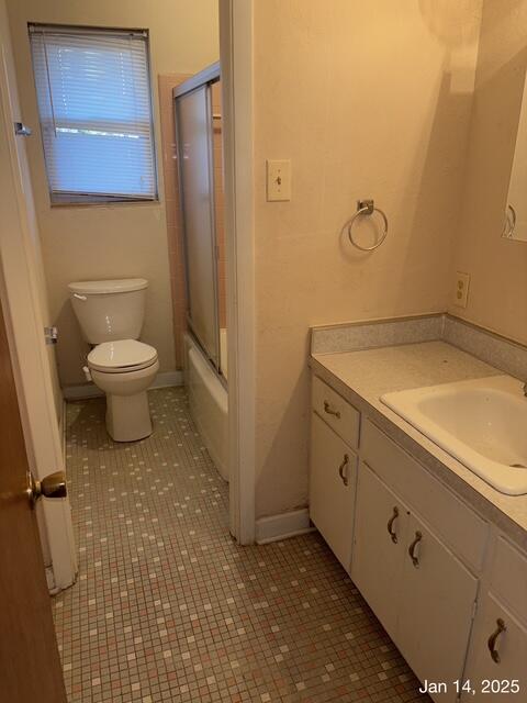 full bathroom with toilet, shower / bath combination with glass door, tile patterned floors, and vanity