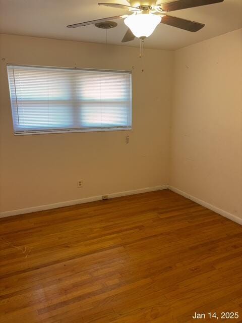 unfurnished room featuring ceiling fan, a wealth of natural light, and hardwood / wood-style flooring