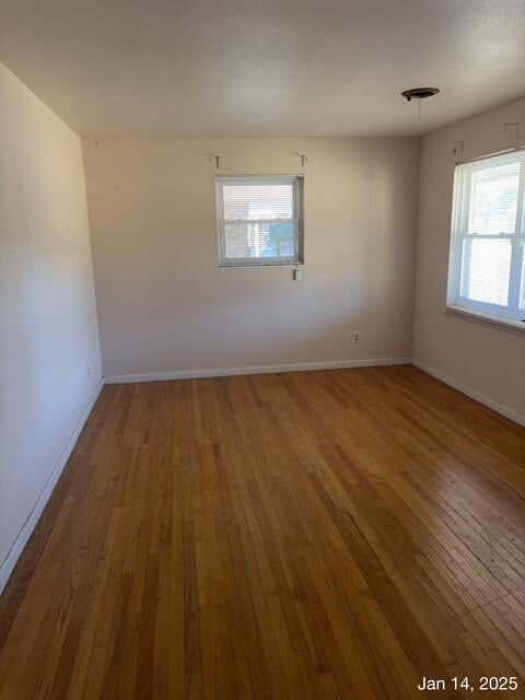 unfurnished room with wood-type flooring