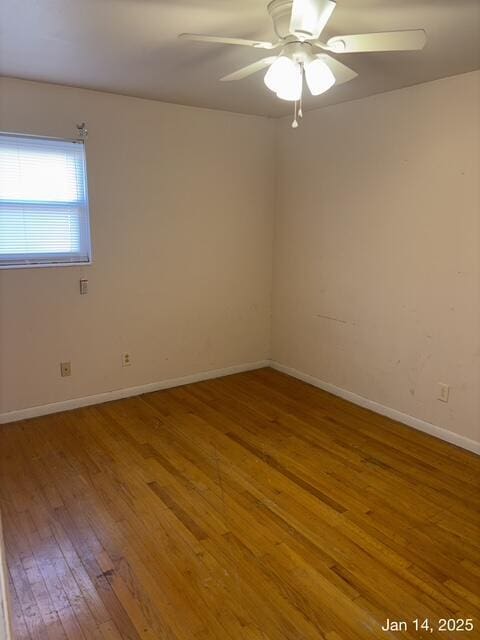 spare room with ceiling fan and wood-type flooring