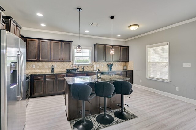 251 Wentworth Pl, Grovetown, GA 30813 - kitchen with stainless steel refrigerator with ice dispenser, dark stone counters, dark brown cabinetry, crown molding, and backsplash