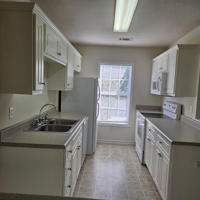 5102 Wheeler Lake Rd, Augusta, GA 30909 - kitchen featuring white appliances, a sink, baseboards, and white cabinets
