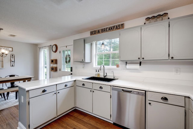 188 Marks Walden Rd, Blythe, GA 30805 - kitchen featuring dishwasher, a sink, a peninsula, dark wood finished floors, and a textured ceiling