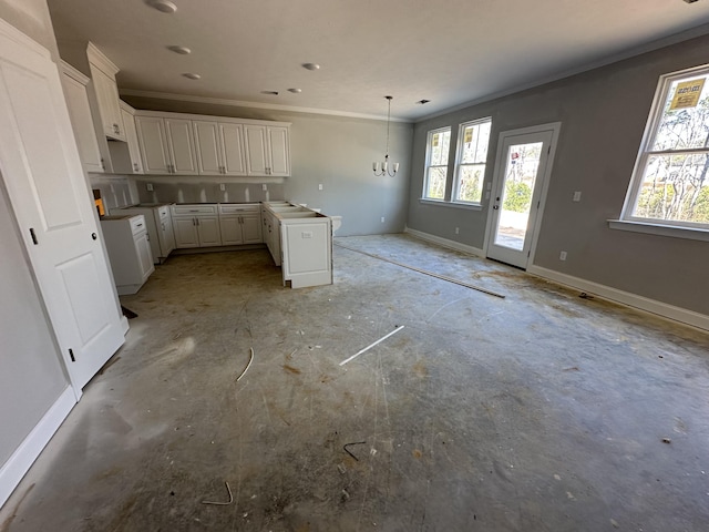 kitchen featuring an inviting chandelier, decorative light fixtures, ornamental molding, and white cabinets