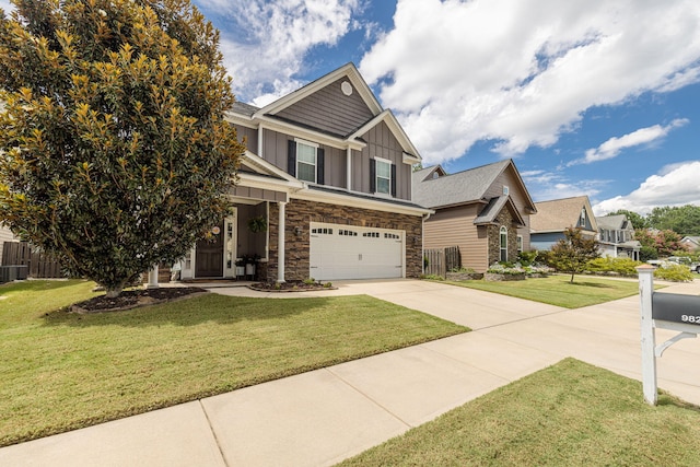 craftsman inspired home featuring a garage and a front lawn