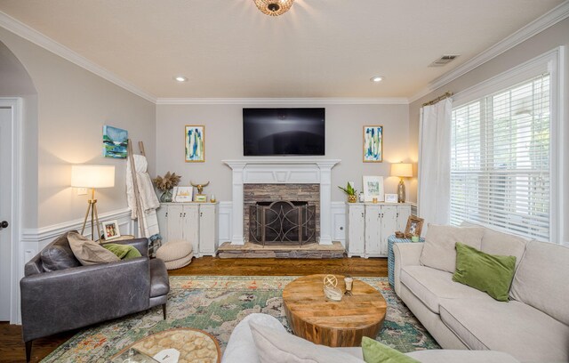 living room featuring a fireplace, hardwood / wood-style floors, and ornamental molding