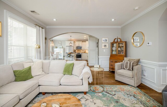 living room with dark hardwood / wood-style flooring and crown molding