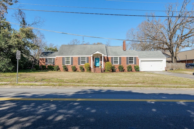 view of front of home featuring fence, driveway, an attached garage, a front lawn, and brick siding