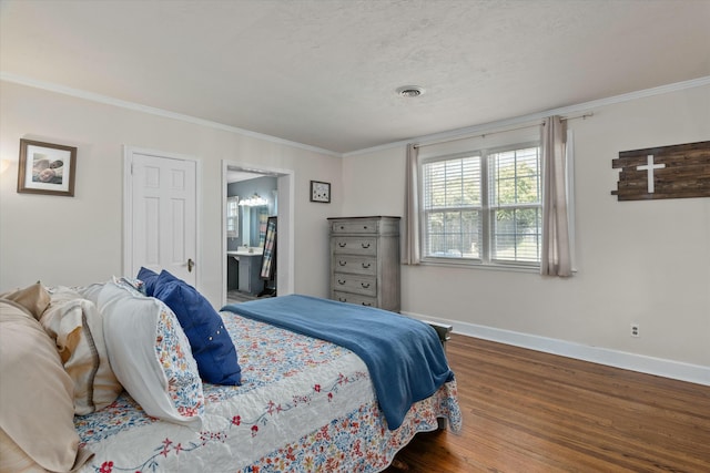 bedroom with visible vents, crown molding, baseboards, wood finished floors, and a textured ceiling