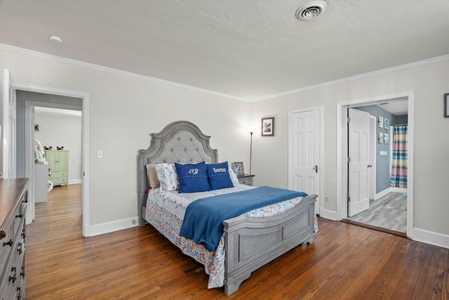 bedroom featuring visible vents, baseboards, and wood-type flooring