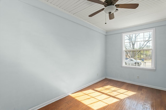 empty room featuring baseboards, a ceiling fan, and hardwood / wood-style flooring