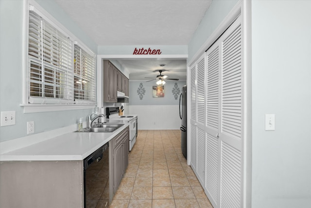 kitchen featuring ceiling fan, dishwasher, wainscoting, freestanding refrigerator, and white electric stove