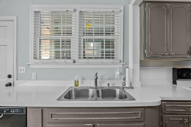 kitchen featuring a sink, dark brown cabinetry, dishwasher, and light countertops