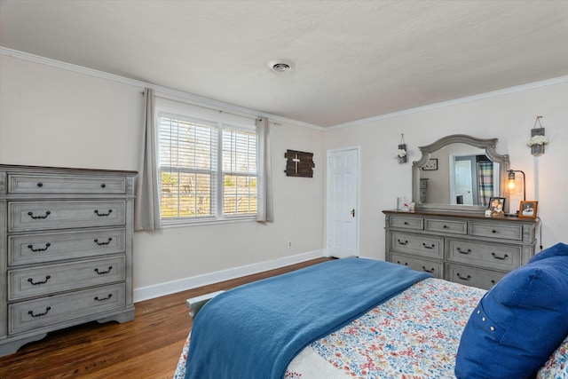 bedroom with dark wood-style floors, visible vents, baseboards, and ornamental molding